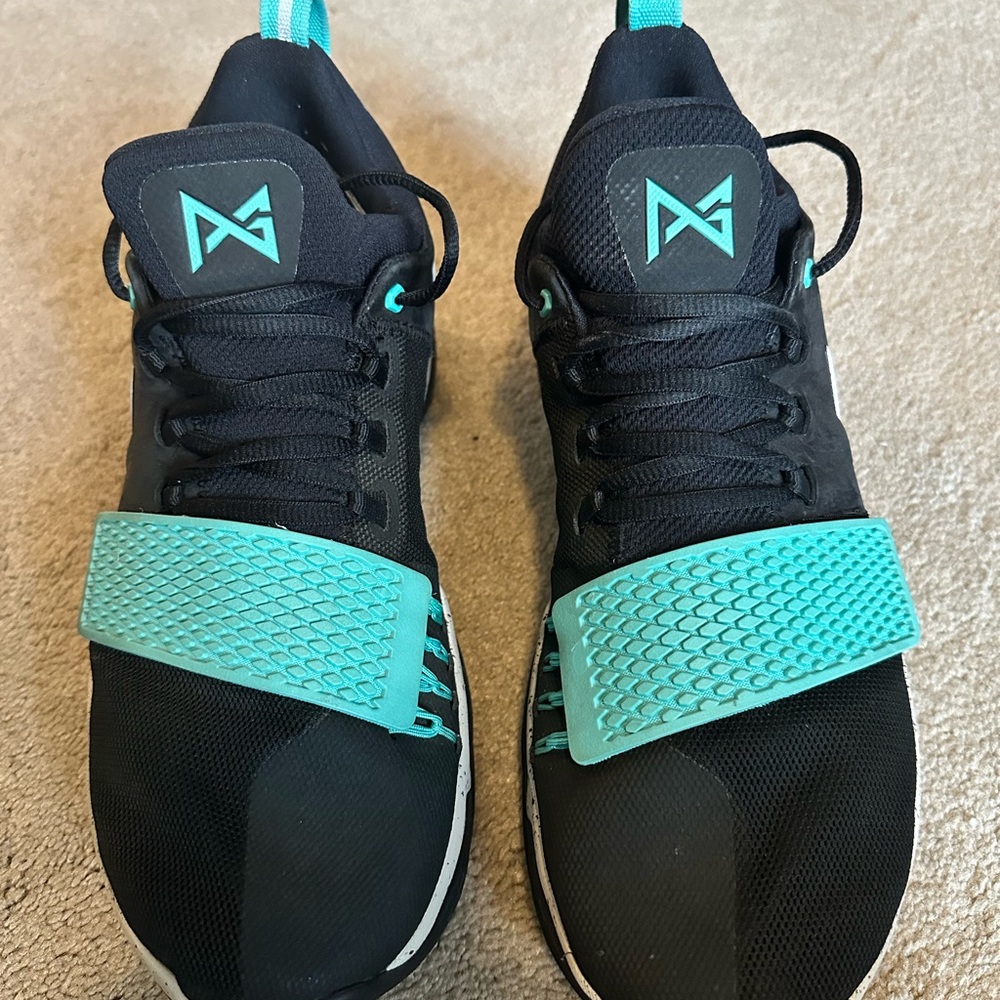 Nike Black Paul George basketball shoes with Teal Highlights